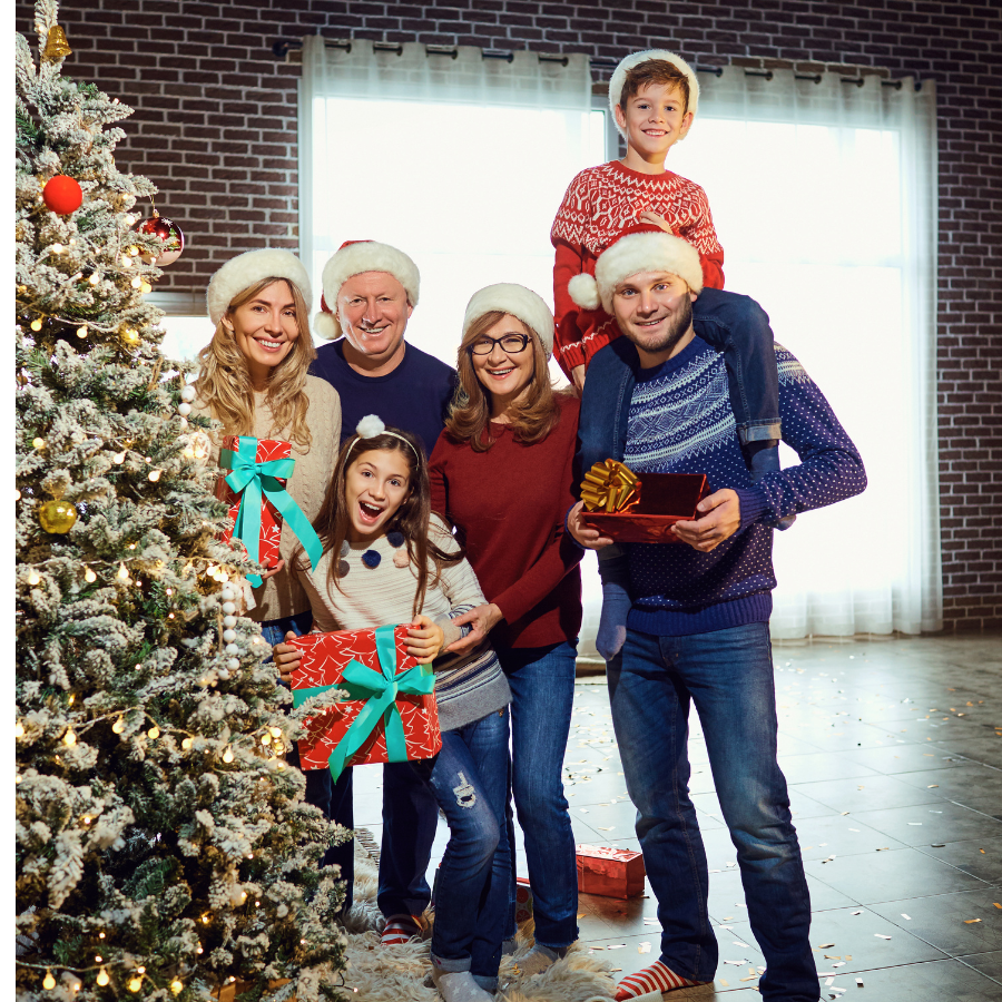 A nuclear family celebrating Christmas around a decorated tree, showcasing fun Christmas ideas for festive family bonding