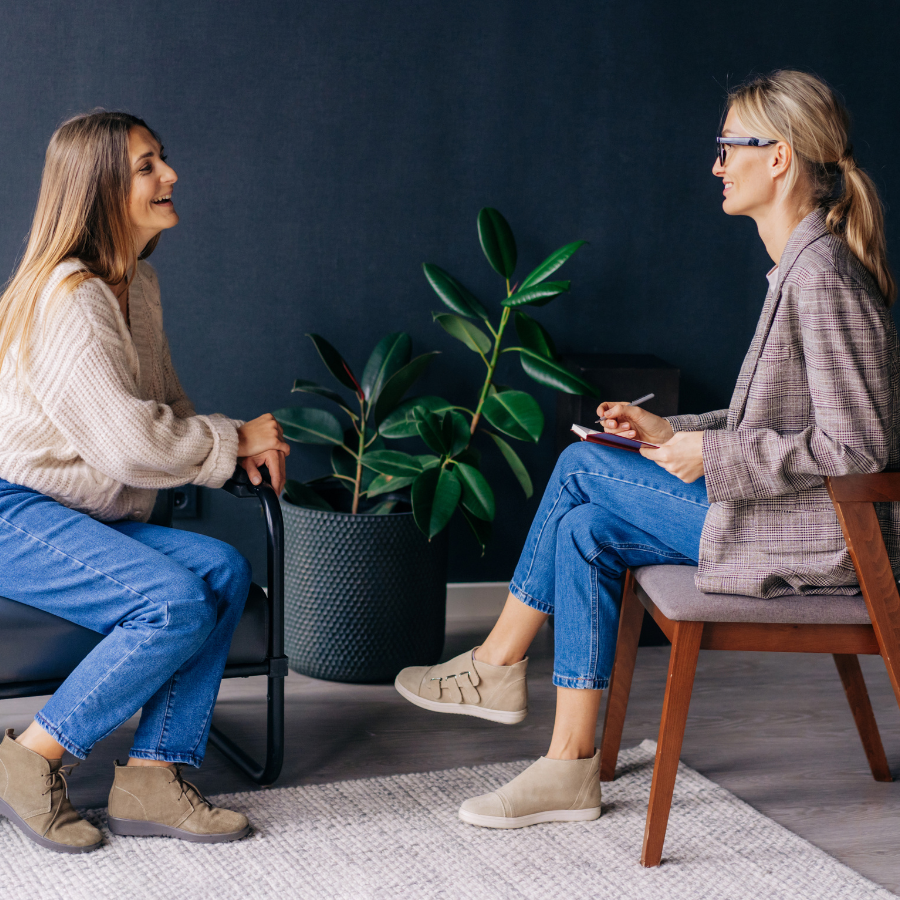  A woman receiving advice from a counselor, seeking postpartum support for mental and emotional well-being